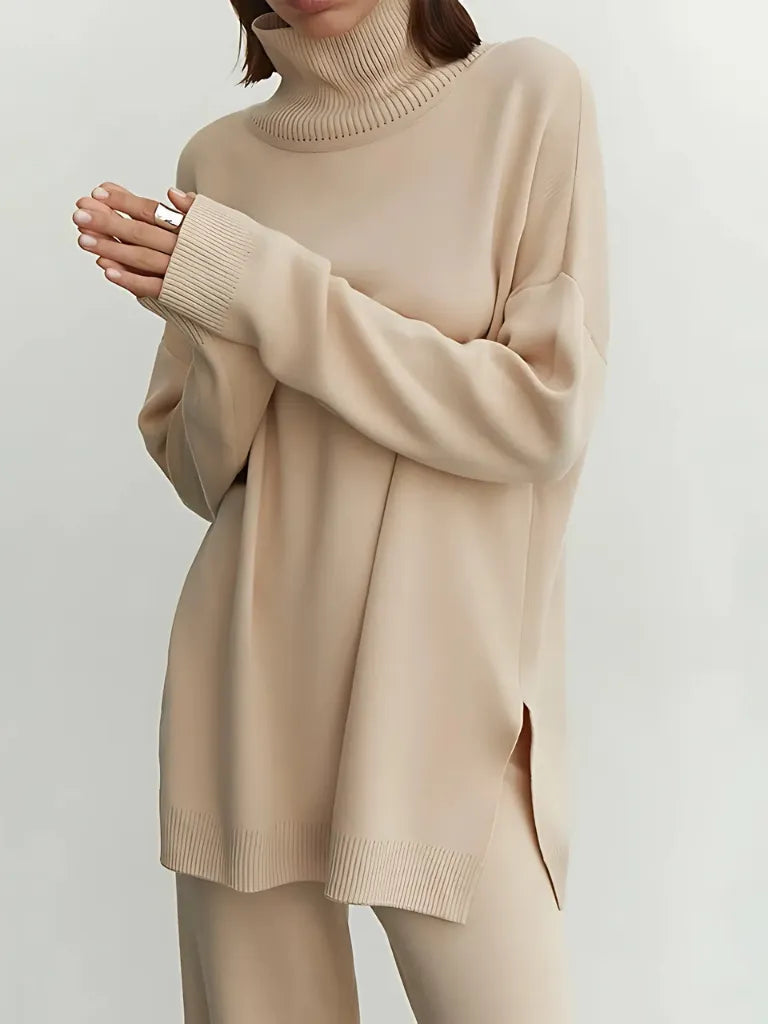Beige sweater worn by a person on a plain background