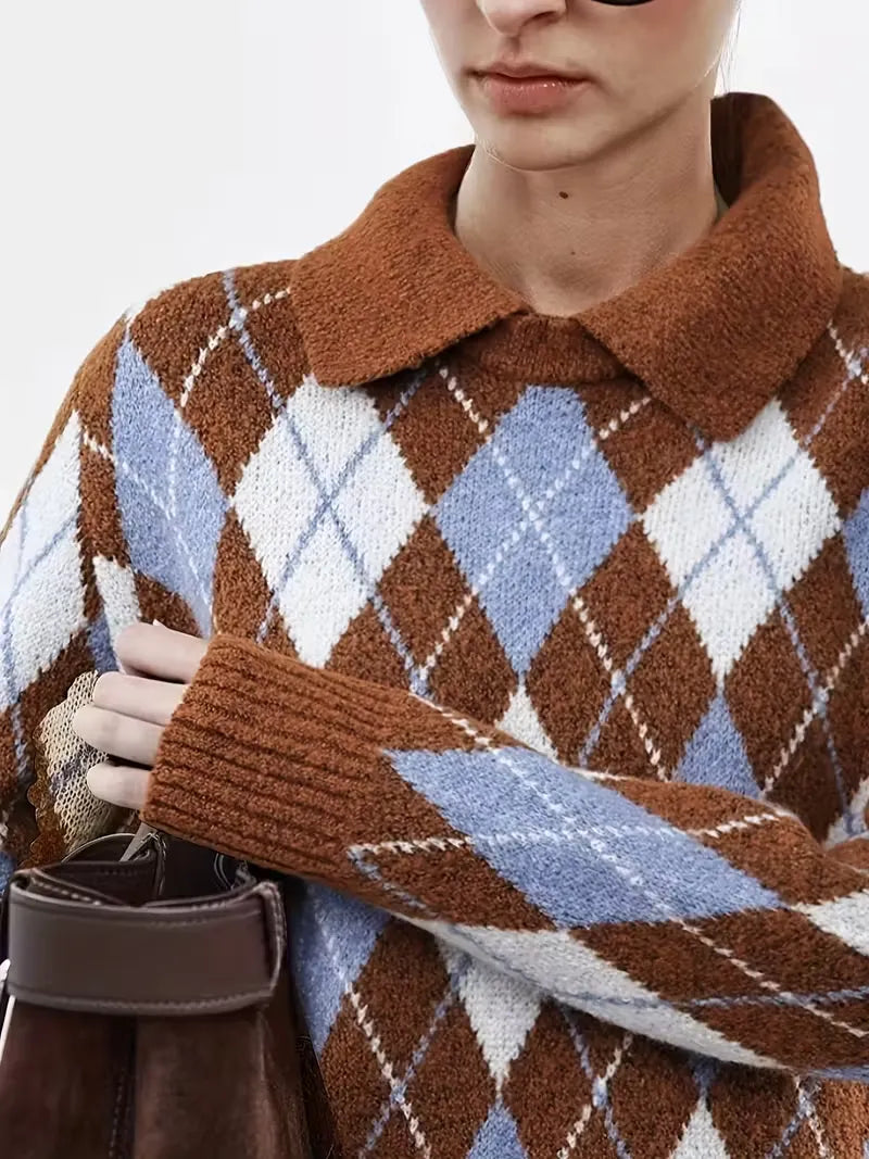 Person wearing a brown argyle sweater with a white background
