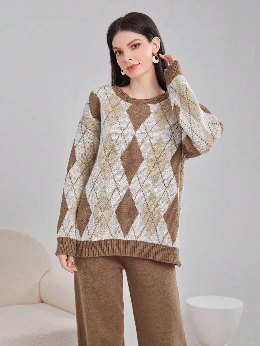 Woman wearing a brown and beige argyle sweater and pants on a plain background