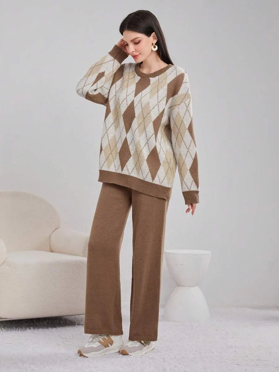 Woman wearing a brown and beige argyle sweater with matching pants in a minimalistic room.
