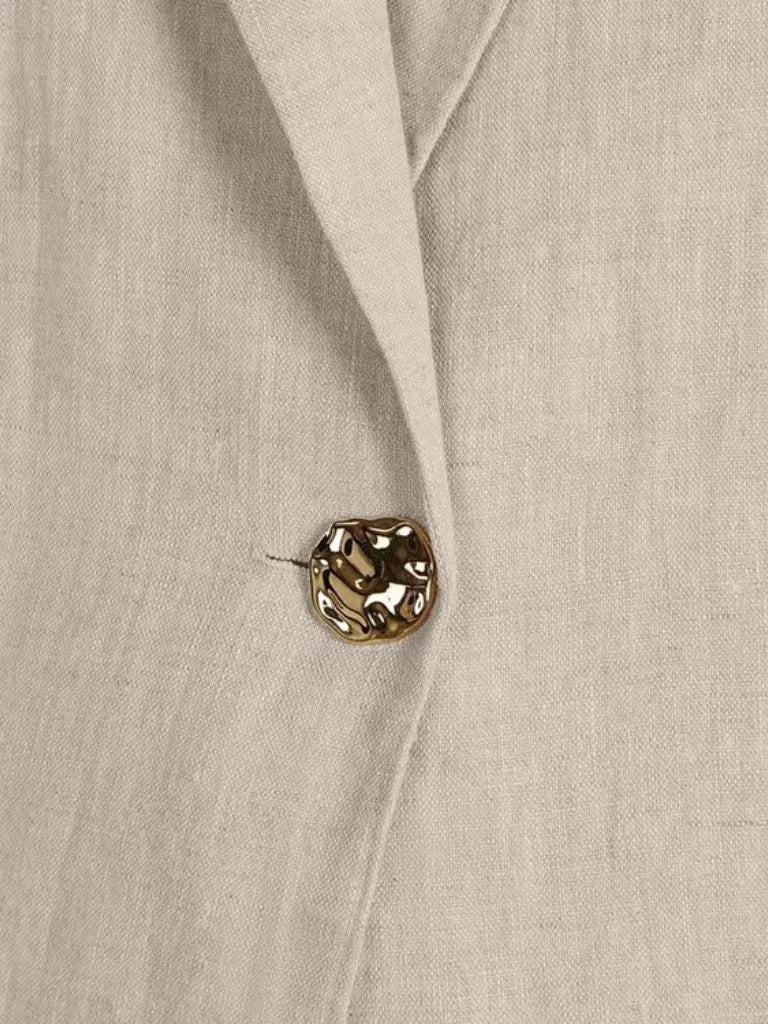 Close-up of a beige fabric with a decorative button