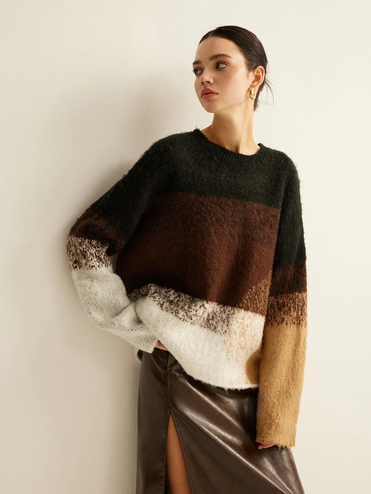 Woman wearing a multicolored sweater with a plain background