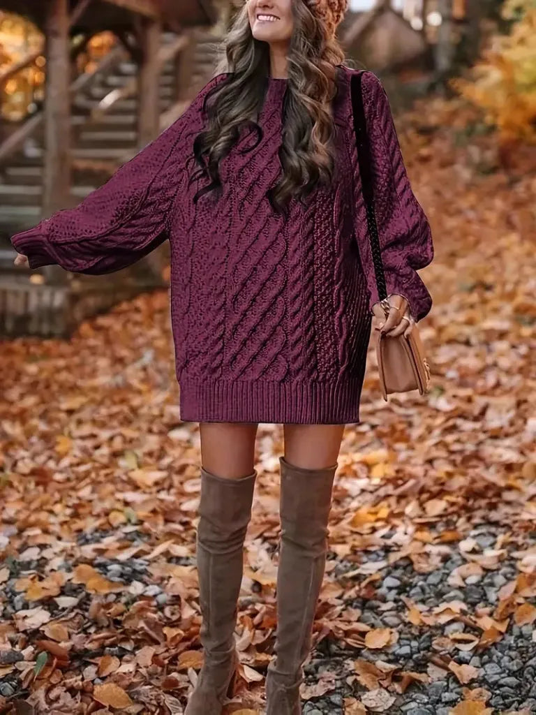 Woman wearing a purple cable knit sweater and brown over-the-knee boots in an autumn setting.