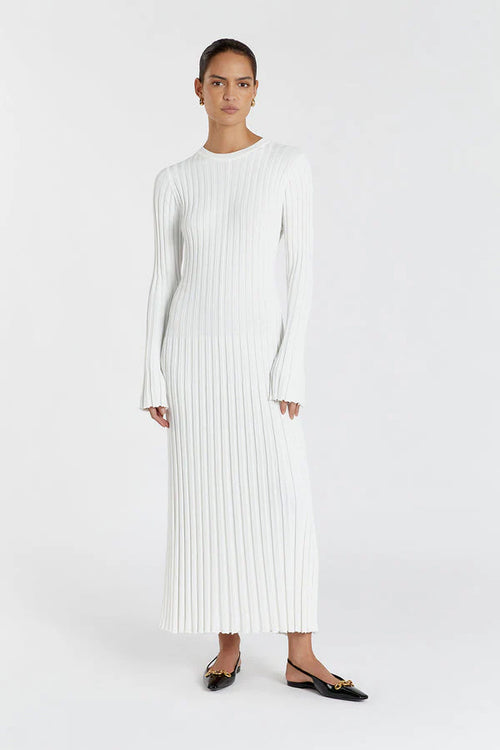 Woman wearing a white ribbed dress on a white background