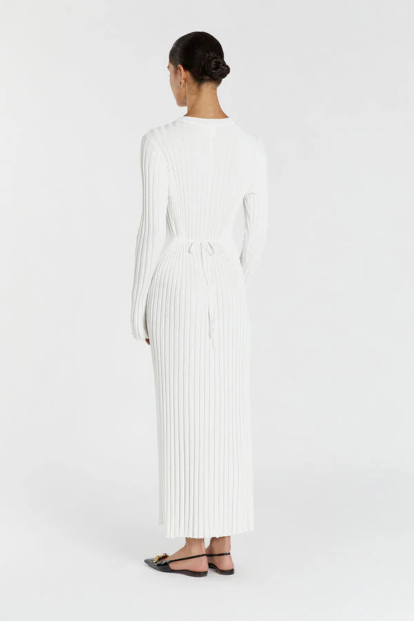 Woman wearing a white pleated dress on a white background