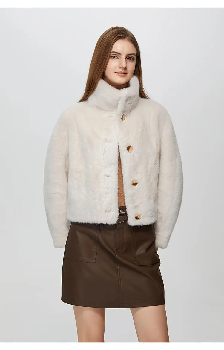 Woman wearing a white puffer jacket over a brown outfit on a white background