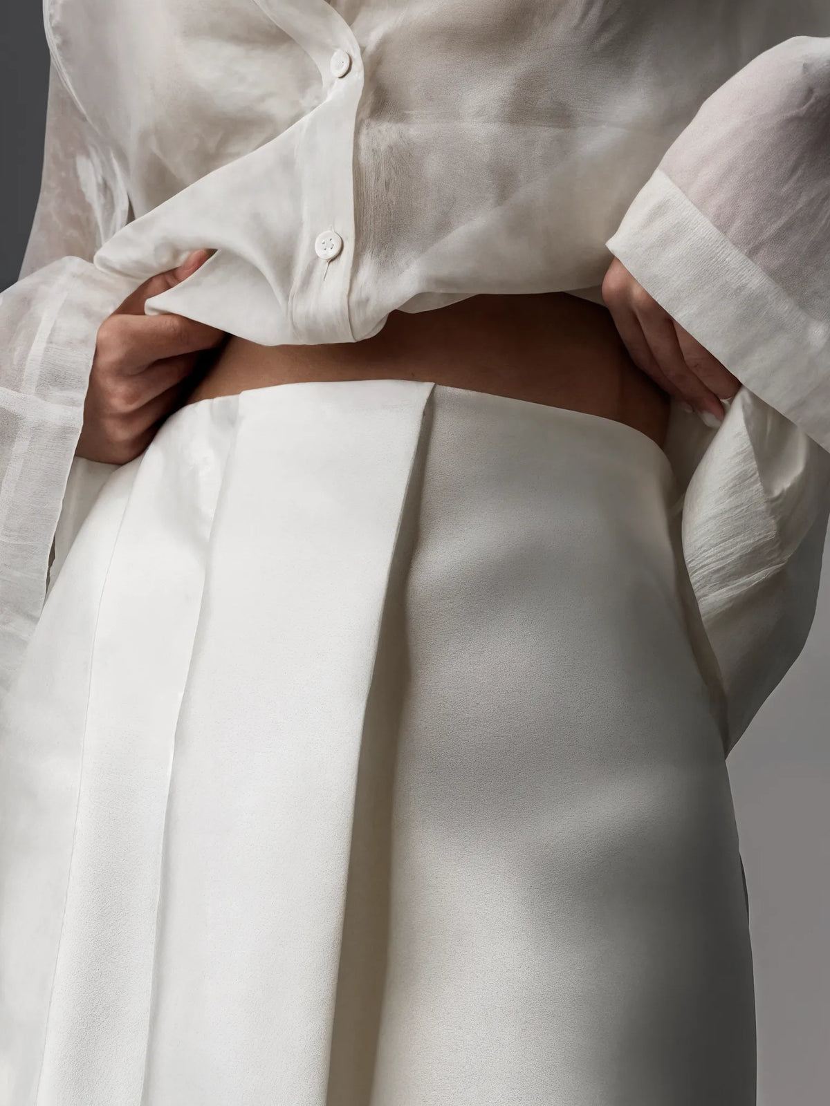 White shirt and pants with a neutral background