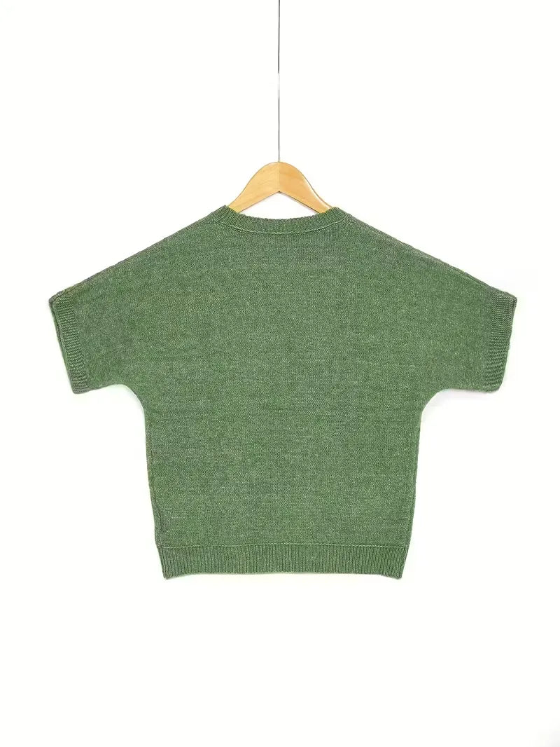 Green sweater on a hanger against a white background