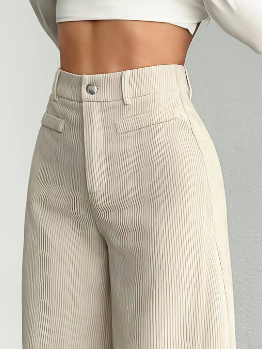 Beige corduroy pants on a plain background