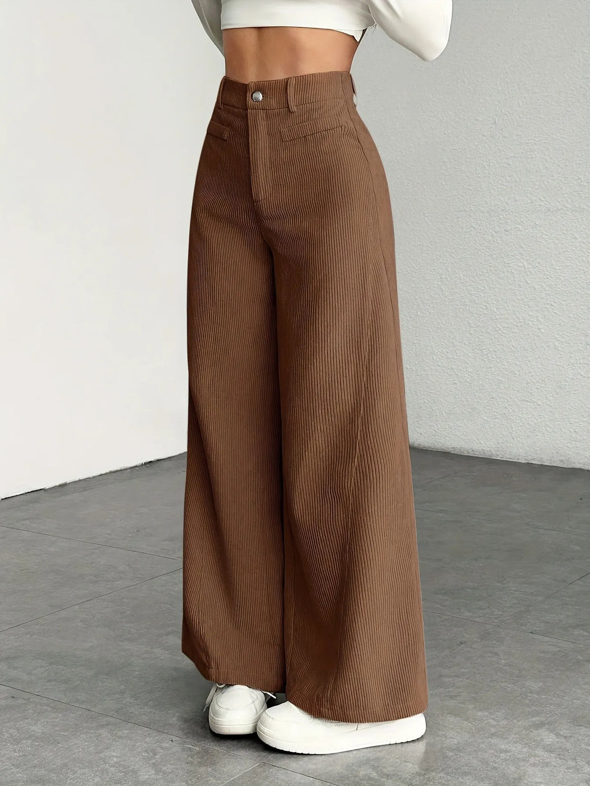 Brown wide-leg pants worn by a person on a plain background
