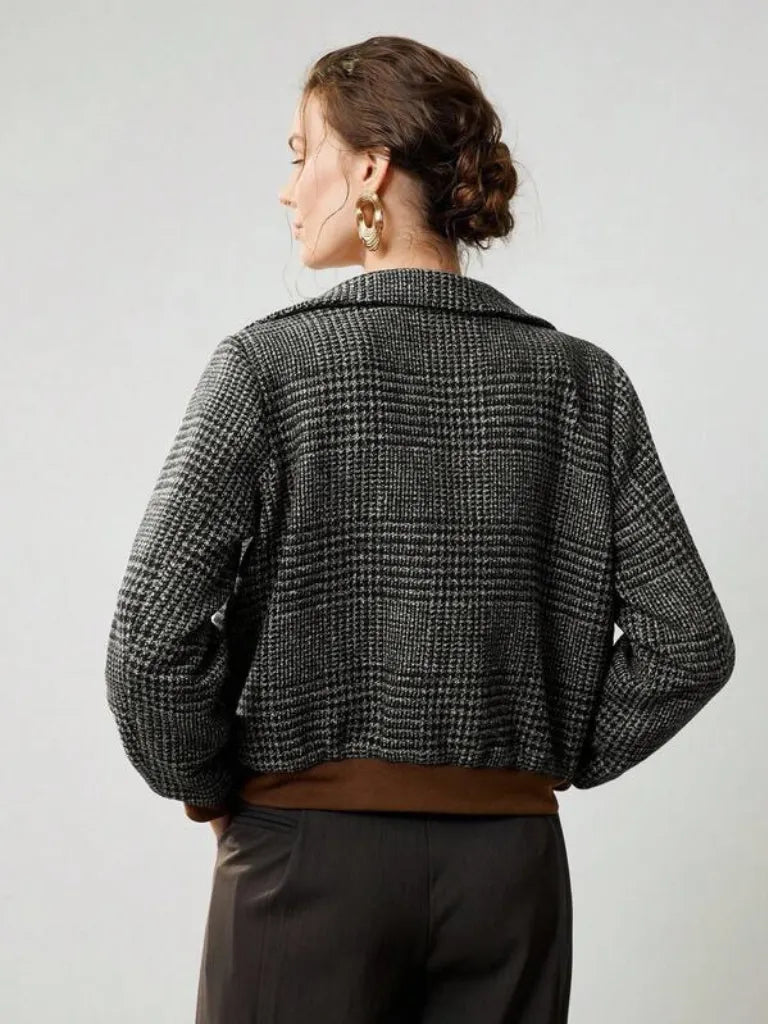 Person wearing a checkered jacket on a plain background