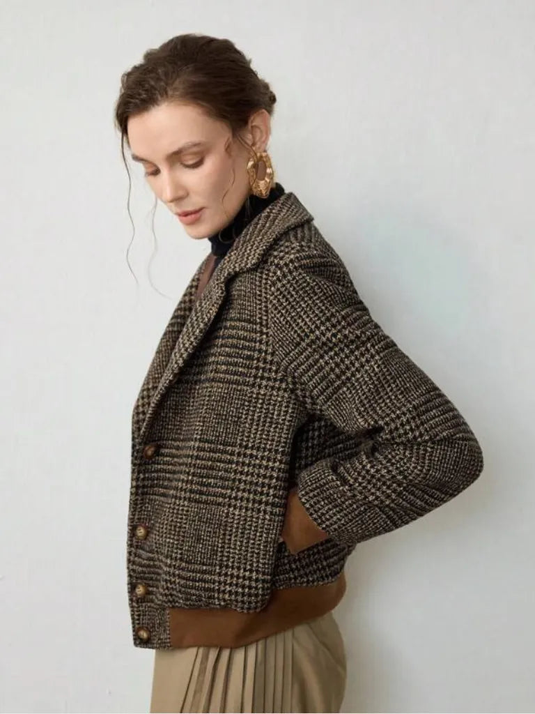Woman wearing a plaid jacket against a white background