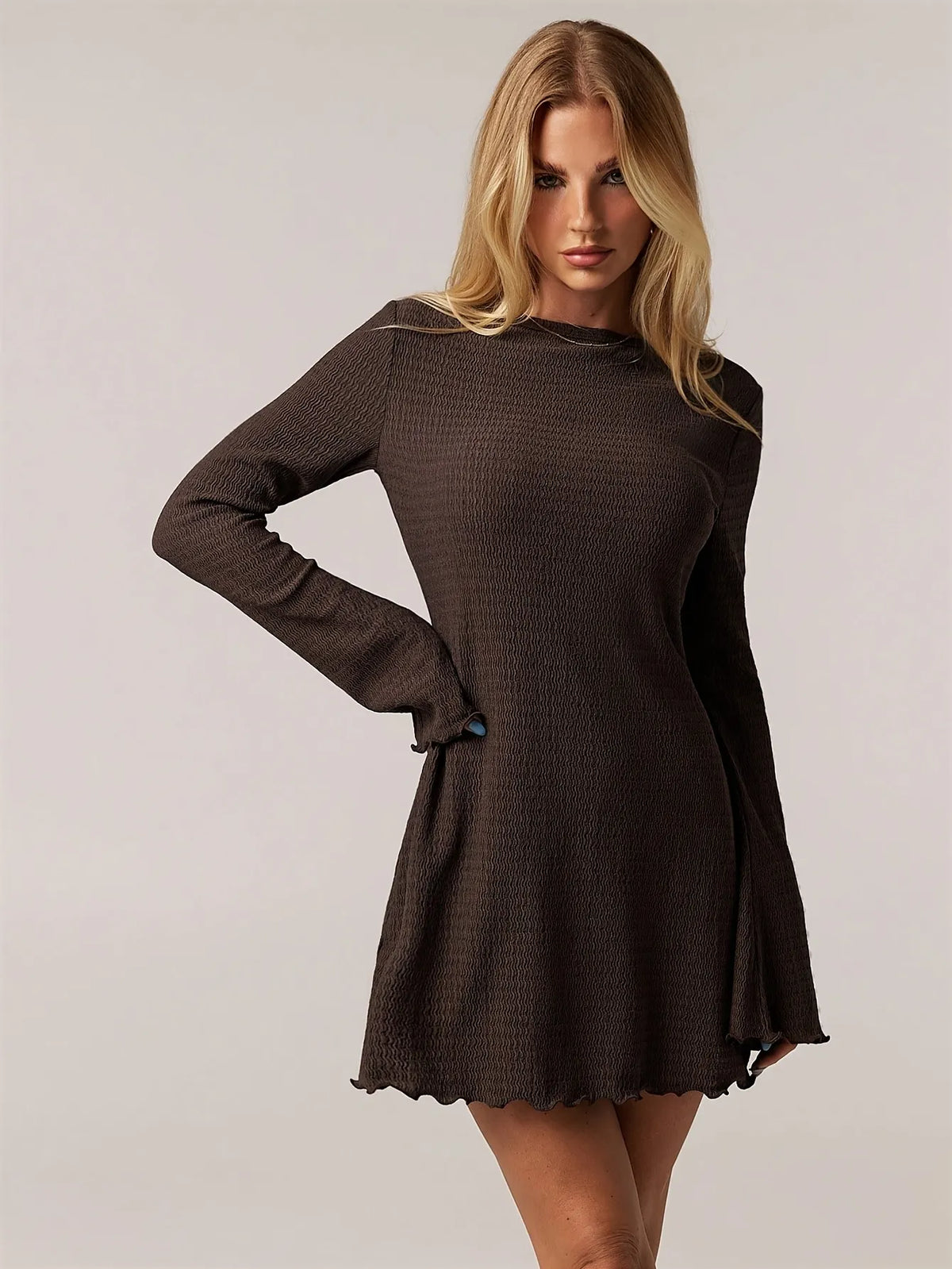 brown ribbed knit long-sleeve mini dress with flared sleeves and round neckline, fitted through the torso, casual yet elegant style