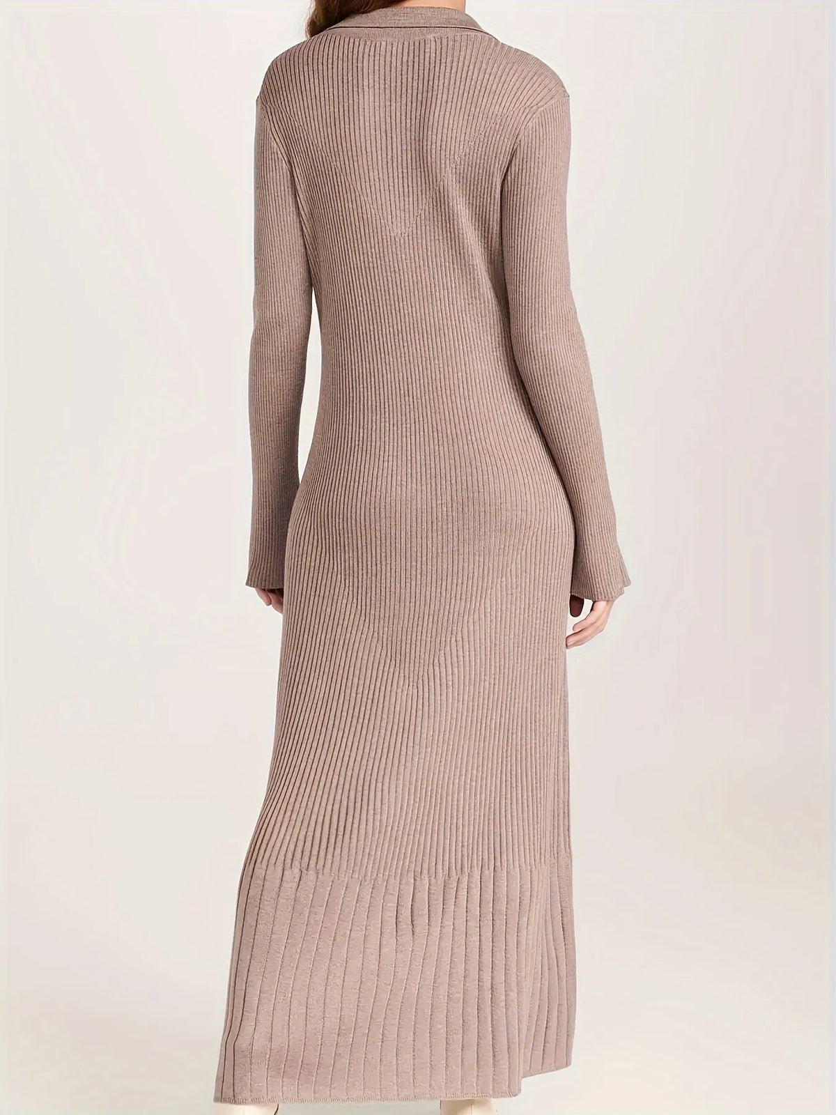 Woman wearing a long brown ribbed dress against a white background